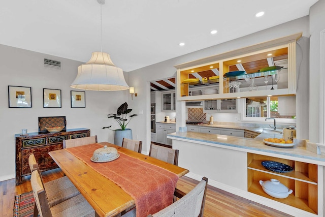 dining space featuring recessed lighting, visible vents, and light wood finished floors