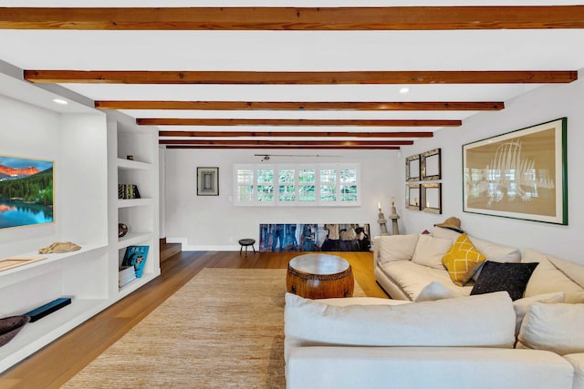 living area featuring recessed lighting, baseboards, wood finished floors, and beam ceiling
