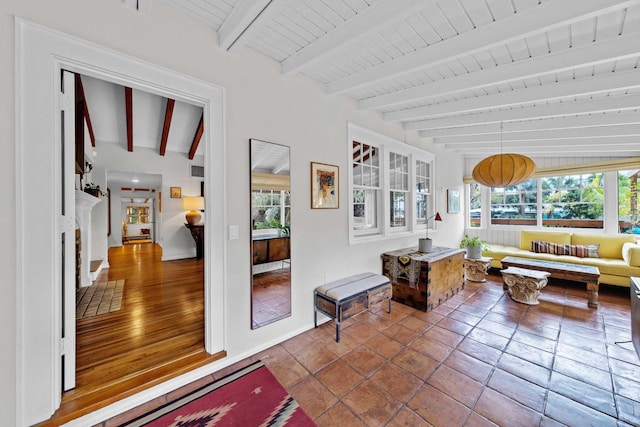 sunroom featuring beam ceiling