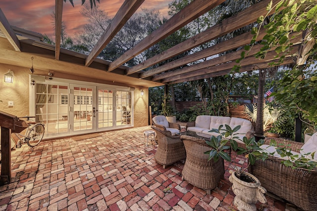 patio terrace at dusk with french doors, fence, a pergola, and an outdoor living space