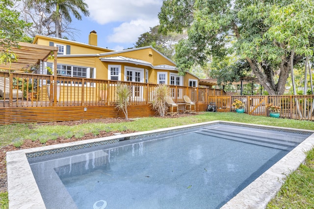 view of pool featuring fence and a wooden deck