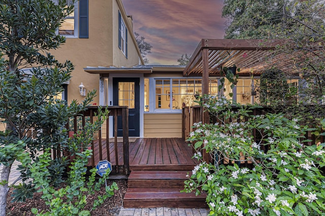wooden deck with a sunroom