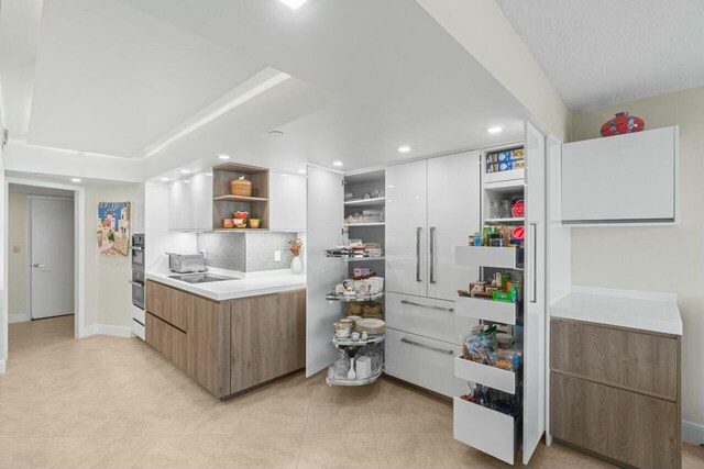 4001 N Ocean Blvd Unit 1602, Boca Raton, FL 33431 - kitchen with open shelves, modern cabinets, light countertops, tasteful backsplash, and recessed lighting