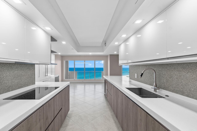 4001 N Ocean Blvd Unit 1602, Boca Raton, FL 33431 - kitchen with modern cabinets, a sink, black electric cooktop, white cabinetry, and recessed lighting