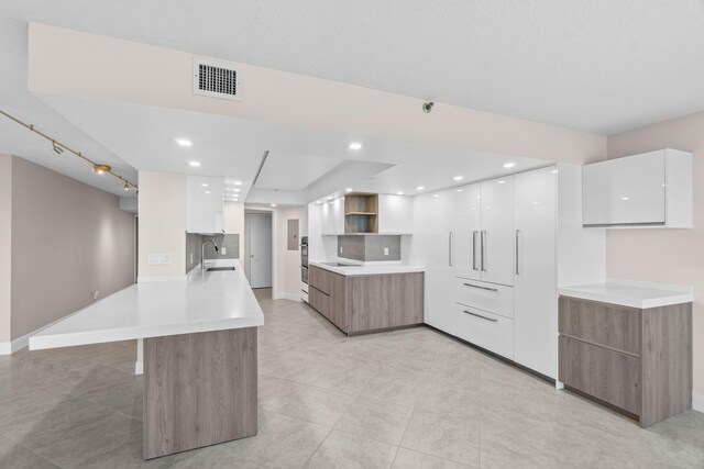 4001 N Ocean Blvd Unit 1602, Boca Raton, FL 33431 - kitchen with modern cabinets, a sink, a peninsula, open shelves, and white cabinetry