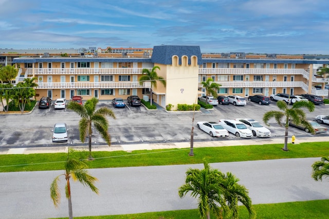 view of building exterior featuring uncovered parking
