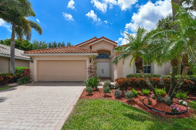 7130 Catania Dr, Boynton Beach, FL 33472 - mediterranean / spanish home with stucco siding, a tile roof, a garage, and decorative driveway