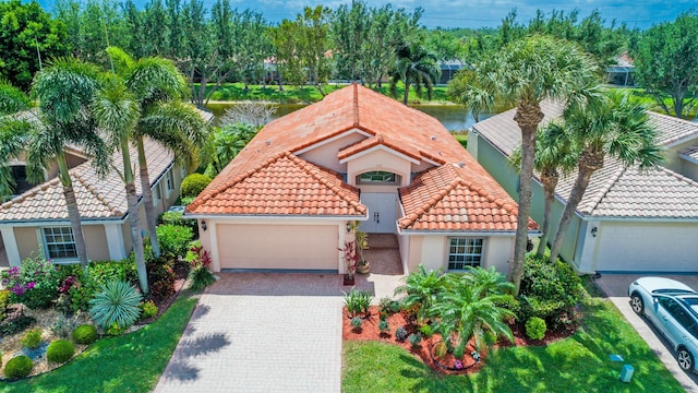 7130 Catania Dr, Boynton Beach, FL 33472 - view of front of property with a tile roof, stucco siding, a garage, and driveway