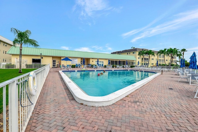 pool with fence and a patio