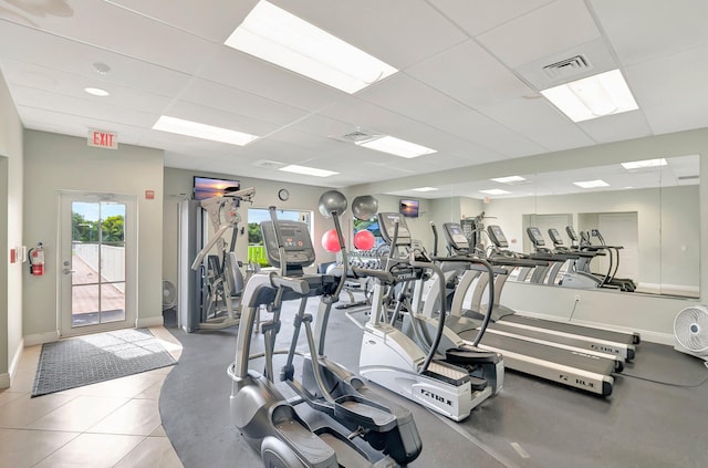 gym featuring a paneled ceiling, baseboards, and visible vents