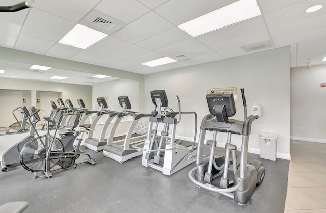 gym featuring a drop ceiling, baseboards, and visible vents