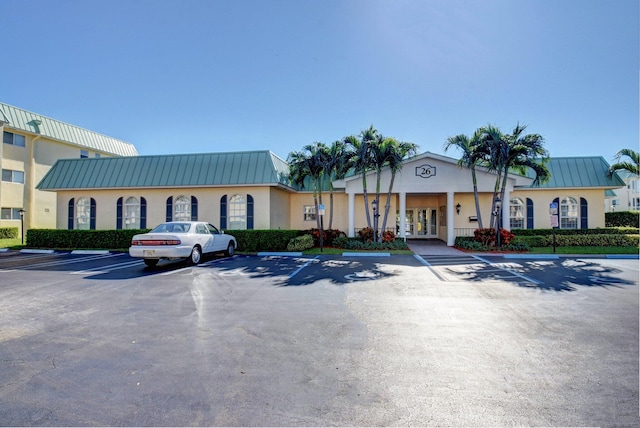 view of building exterior featuring uncovered parking