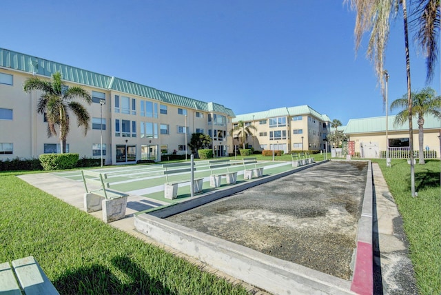 view of community featuring a residential view, shuffleboard, and a yard