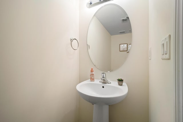 bathroom with visible vents and a sink