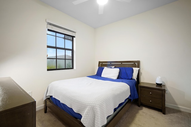 carpeted bedroom with baseboards and a ceiling fan