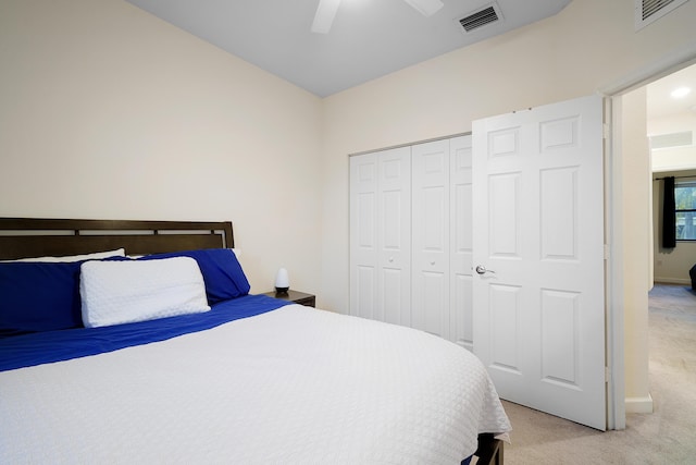 bedroom featuring a closet, visible vents, a ceiling fan, and light carpet