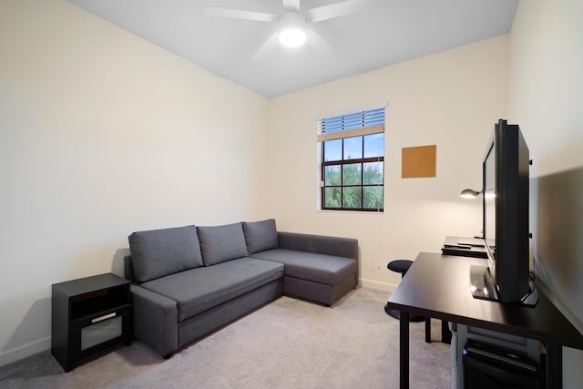 living room featuring baseboards, ceiling fan, and carpet