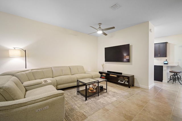 living area with a ceiling fan, baseboards, and visible vents