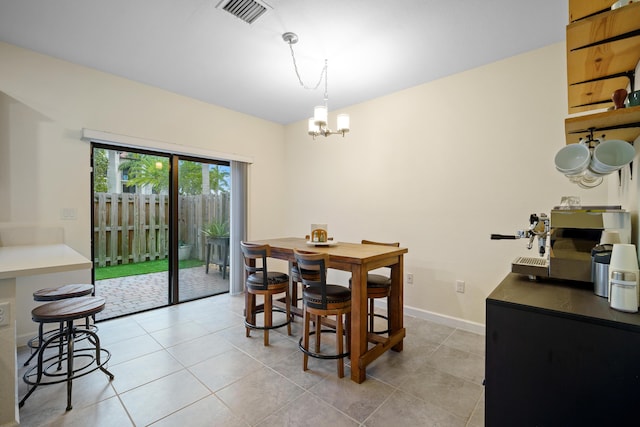 dining area featuring baseboards, visible vents, a chandelier, and light tile patterned floors