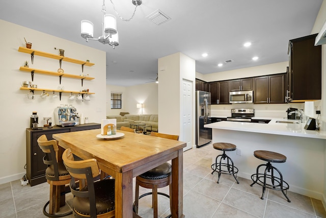 dining space with light tile patterned floors, recessed lighting, a chandelier, and visible vents