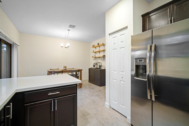 kitchen featuring light countertops, light tile patterned floors, stainless steel fridge with ice dispenser, a chandelier, and hanging light fixtures