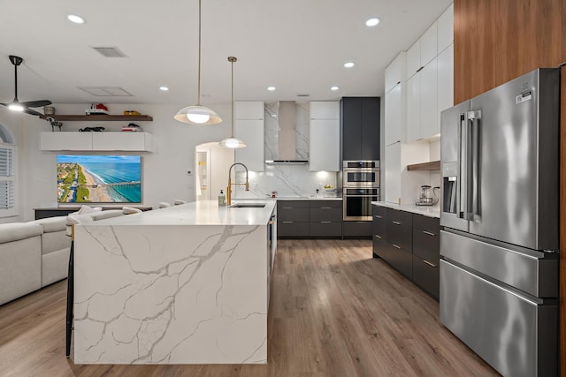15415 Alexander Run, Jupiter, FL 33478 - kitchen featuring appliances with stainless steel finishes, modern cabinets, a sink, wall chimney exhaust hood, and recessed lighting