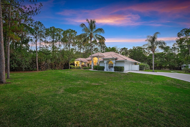 15415 Alexander Run, Jupiter, FL 33478 - mediterranean / spanish-style home with driveway, a yard, an attached garage, and stucco siding