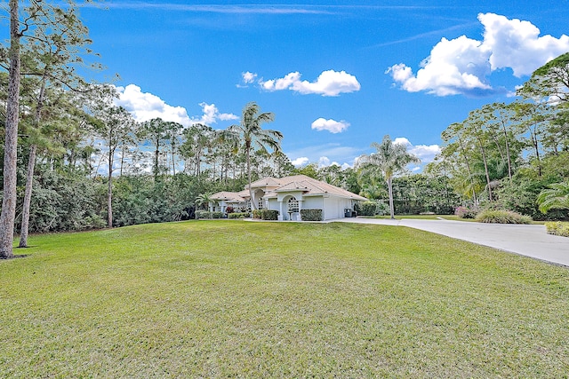 mediterranean / spanish home with driveway, a front lawn, and an attached garage