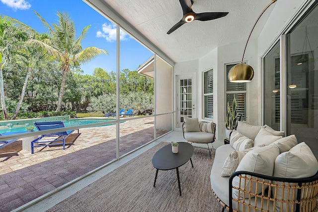 sunroom featuring a ceiling fan