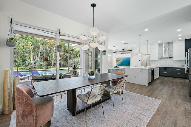 dining room featuring wood finished floors and recessed lighting