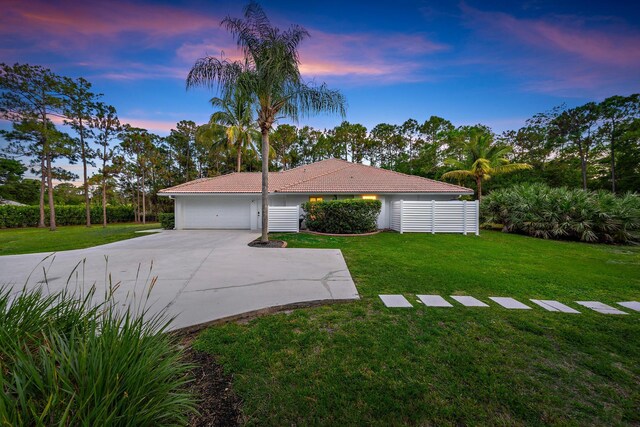 15415 Alexander Run, Jupiter, FL 33478 - view of front of home with a tiled roof, a lawn, concrete driveway, and a garage