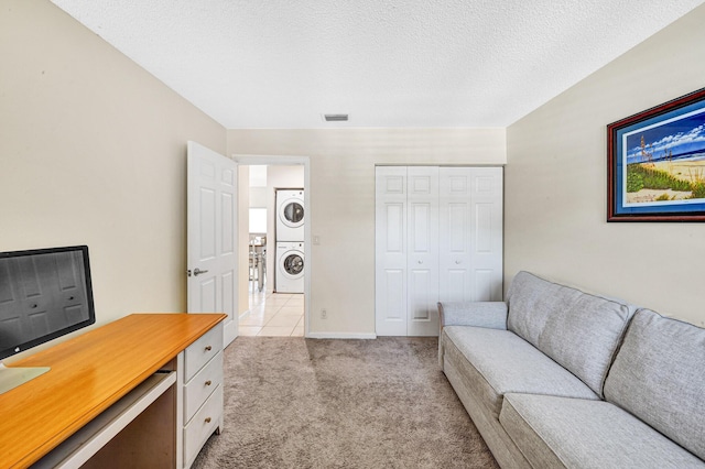 3050 Norwood Pl Unit N208, Boca Raton, FL 33431 - office area featuring a textured ceiling, light colored carpet, visible vents, stacked washer / dryer, and baseboards