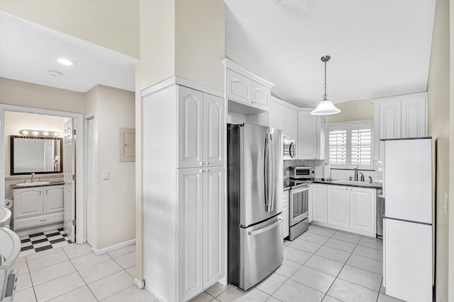 3050 Norwood Pl Unit N208, Boca Raton, FL 33431 - kitchen with pendant lighting, a sink, white cabinets, and stainless steel appliances