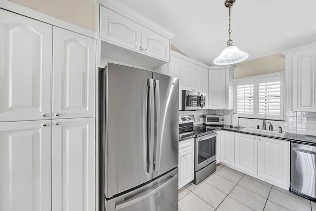 3050 Norwood Pl Unit N208, Boca Raton, FL 33431 - kitchen featuring appliances with stainless steel finishes, a sink, white cabinetry, and dark countertops