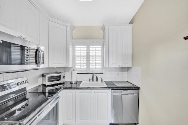3050 Norwood Pl Unit N208, Boca Raton, FL 33431 - kitchen featuring a sink, appliances with stainless steel finishes, dark countertops, and white cabinetry