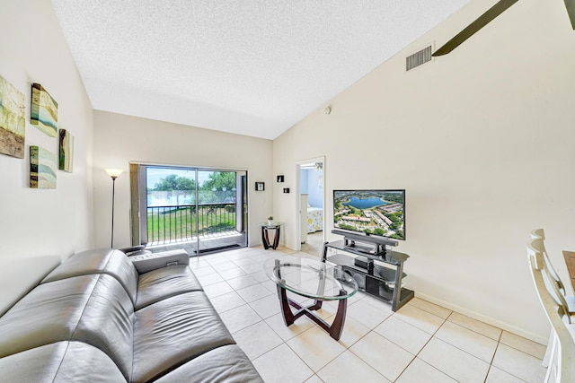 3050 Norwood Pl Unit N208, Boca Raton, FL 33431 - living room with high vaulted ceiling, light tile patterned floors, a textured ceiling, visible vents, and baseboards