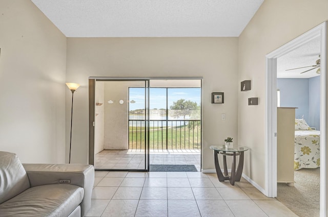 3050 Norwood Pl Unit N208, Boca Raton, FL 33431 - doorway to outside featuring a textured ceiling, light tile patterned floors, ceiling fan, and a water view