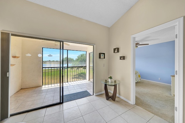 3050 Norwood Pl Unit N208, Boca Raton, FL 33431 - doorway with baseboards, vaulted ceiling, light tile patterned floors, ceiling fan, and a water view