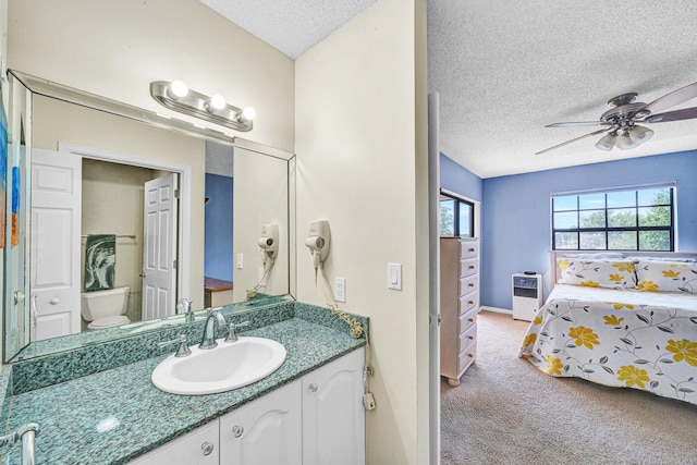 3050 Norwood Pl Unit N208, Boca Raton, FL 33431 - bathroom featuring vanity, baseboards, a textured ceiling, a ceiling fan, and toilet