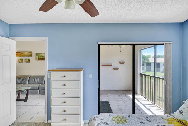 3050 Norwood Pl Unit N208, Boca Raton, FL 33431 - bedroom featuring light tile patterned floors, access to exterior, a textured ceiling, and ceiling fan