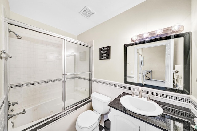 3050 Norwood Pl Unit N208, Boca Raton, FL 33431 - full bath with visible vents, combined bath / shower with glass door, toilet, tile walls, and vanity