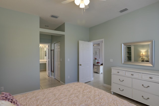 bedroom featuring light tile patterned flooring, baseboards, visible vents, and ensuite bathroom