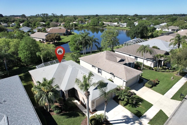 drone / aerial view featuring a residential view and a water view