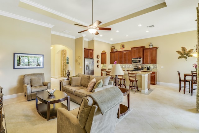 16988 SW Ambrose Way, Port Saint Lucie, FL 34986 - living room featuring visible vents, ornamental molding, ceiling fan, recessed lighting, and arched walkways