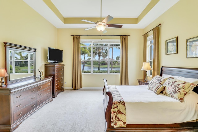 16988 SW Ambrose Way, Port Saint Lucie, FL 34986 - bedroom featuring light colored carpet, a ceiling fan, a raised ceiling, and baseboards
