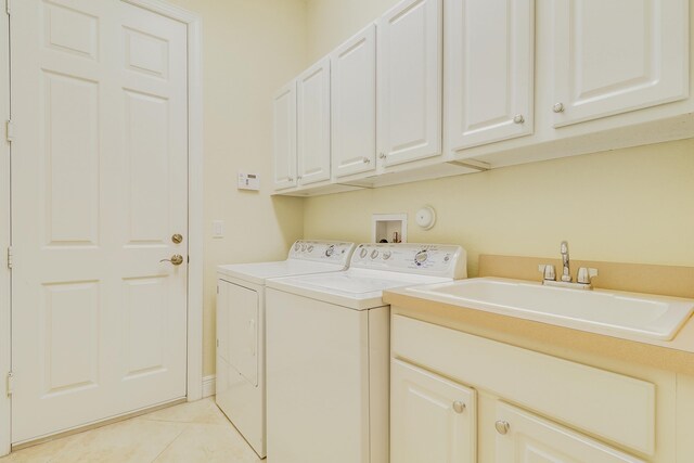 16988 SW Ambrose Way, Port Saint Lucie, FL 34986 - laundry room featuring cabinet space, light tile patterned floors, washing machine and dryer, and a sink