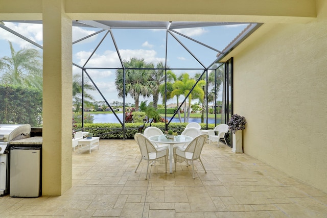 16988 SW Ambrose Way, Port Saint Lucie, FL 34986 - view of patio / terrace featuring glass enclosure, a water view, grilling area, and outdoor dining space