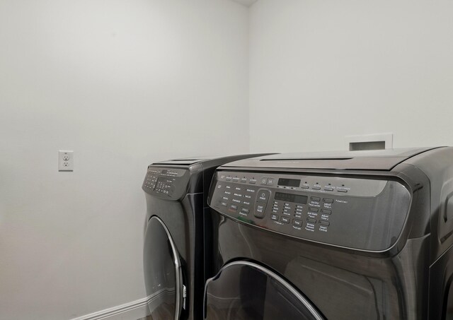 1041 SW Dartmouth Ave, Port Saint Lucie, FL 34953 - washroom with laundry area, separate washer and dryer, and baseboards