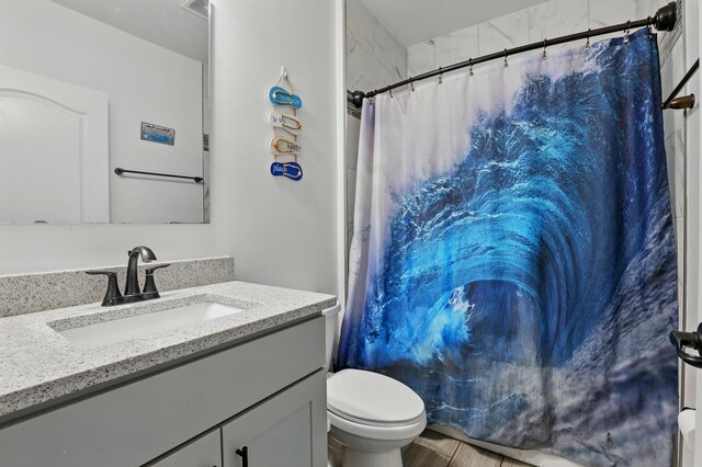 1041 SW Dartmouth Ave, Port Saint Lucie, FL 34953 - bathroom with a shower with shower curtain, vanity, visible vents, and toilet