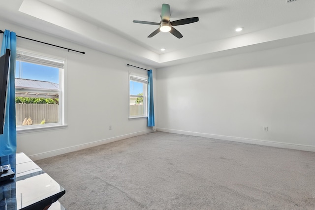 1041 SW Dartmouth Ave, Port Saint Lucie, FL 34953 - unfurnished room with baseboards, recessed lighting, carpet flooring, a ceiling fan, and a raised ceiling